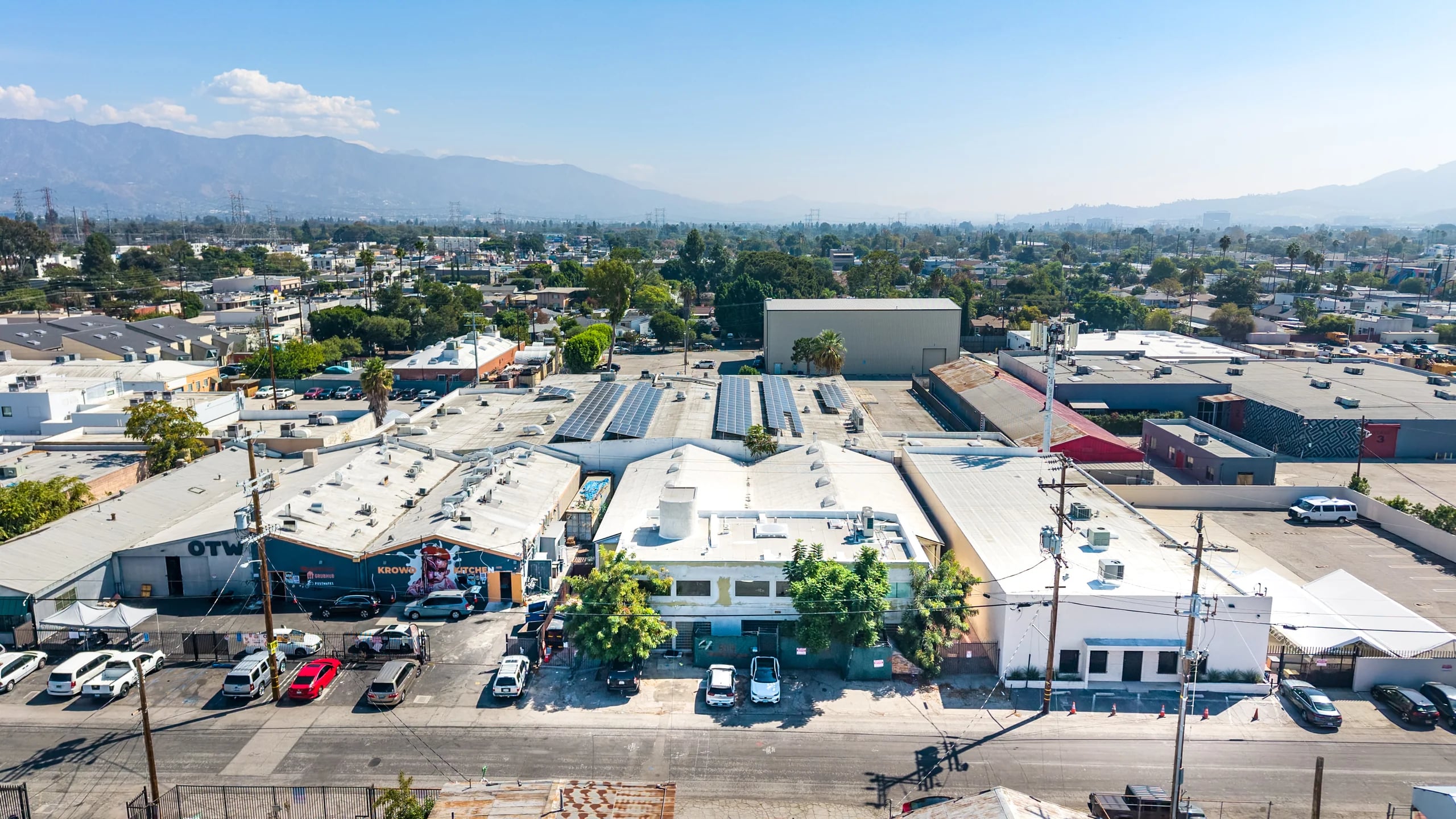 Aerial view of 5514 Satsuma Avenue, centered with its street frontage, front parking area and mountains beyond