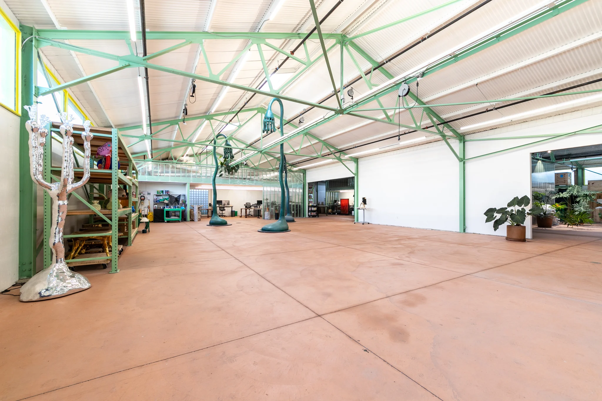 The main studio at 5514 Satsuma Avenue, with open floor space and exposed roof trusses